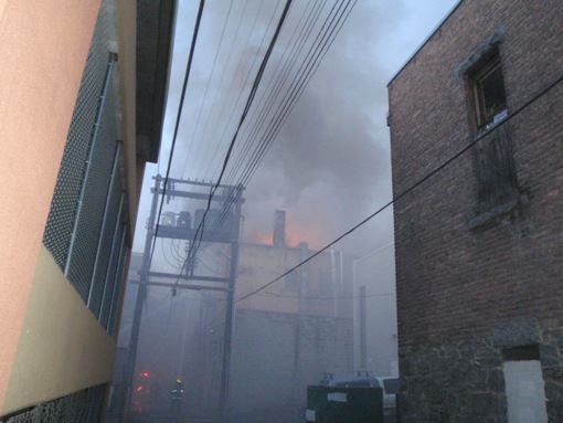 Smoke and flames in back alley Hume Alley